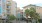 a street with palm trees and buildings