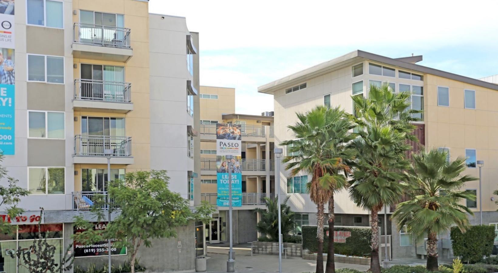 Settle into comfort at Paseo Place a street with palm trees and buildings