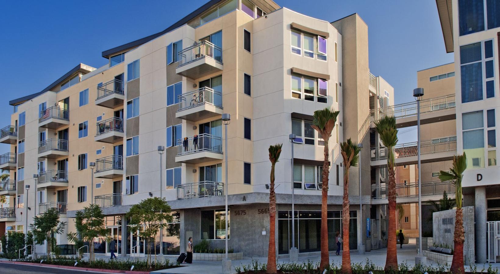 The essence of exceptional living a building with trees and bushes in front of it
