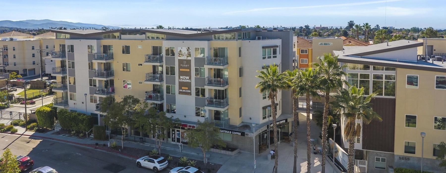 a street with cars and buildings along it