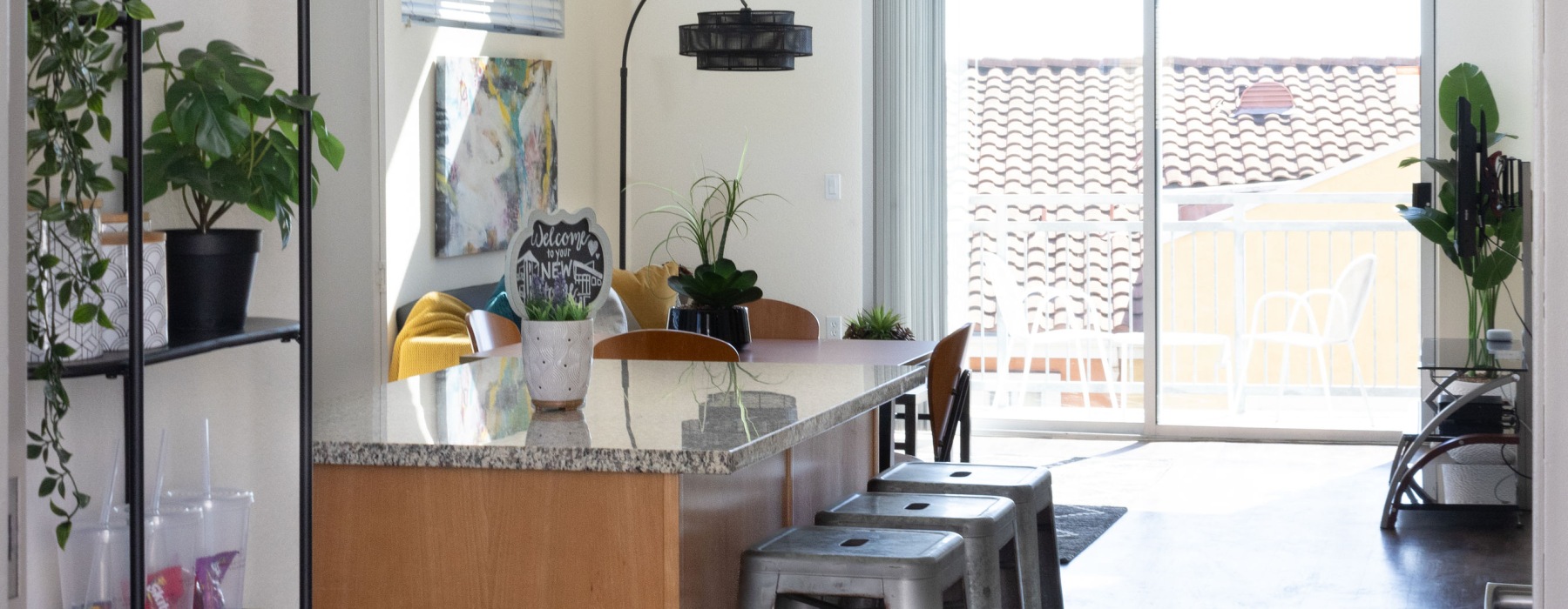 A Kitchen Island with Chairs and Natural Light from Windows