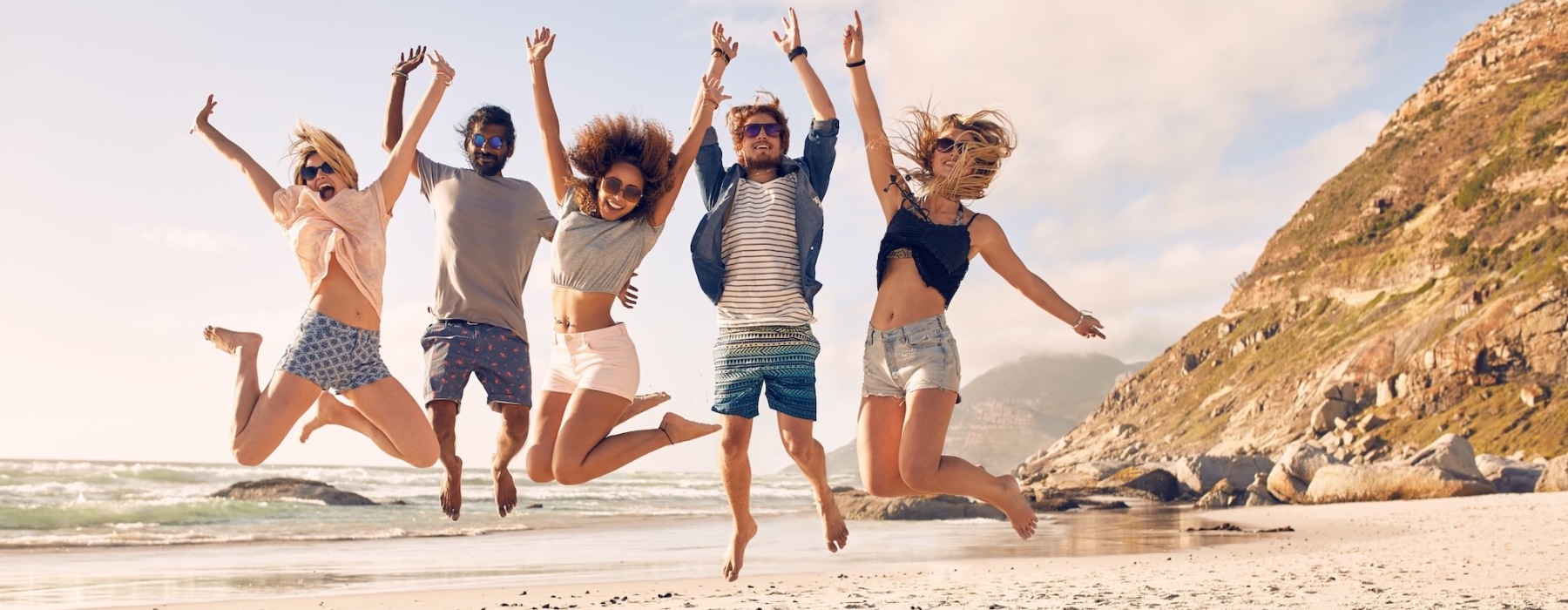 people jumping at the beach
