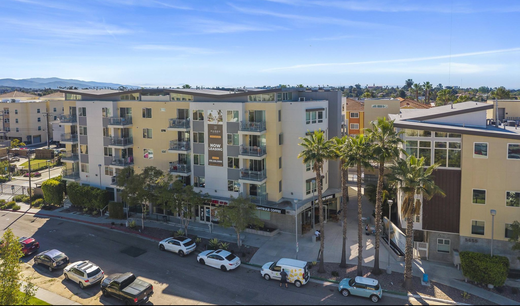 a street with cars and buildings along it