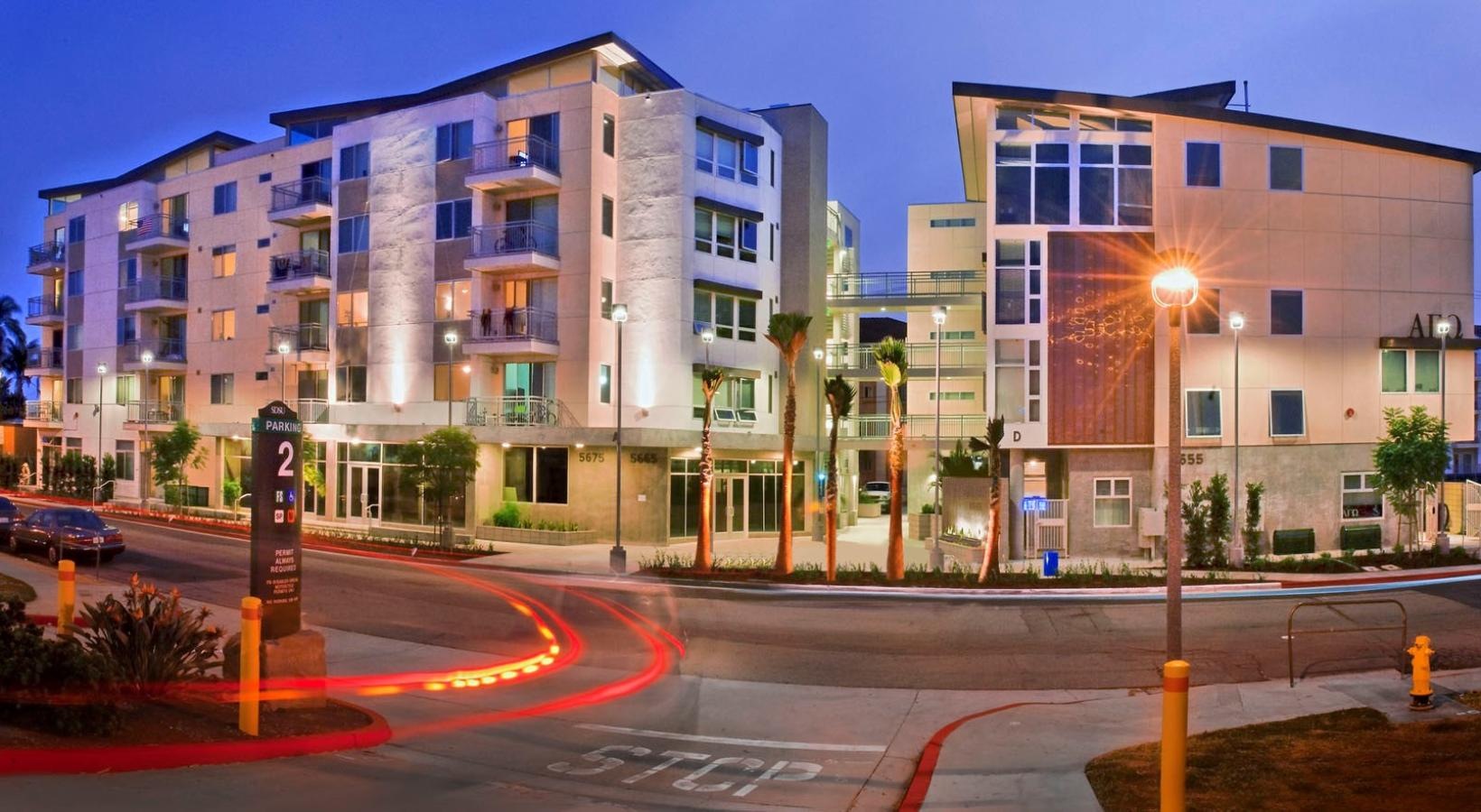 Settle into comfort at Paseo Place a street with cars and buildings along it