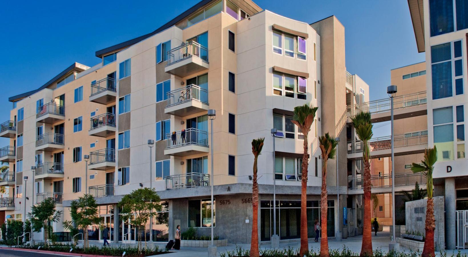 Find your perfect fit at Paseo Place a building with palm trees in front