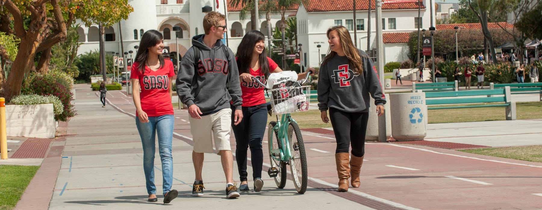 a group of people walking on a sidewalk